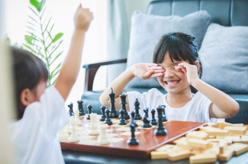 two young children playing chess