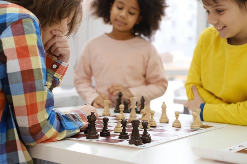 youngsters playing and learning chess