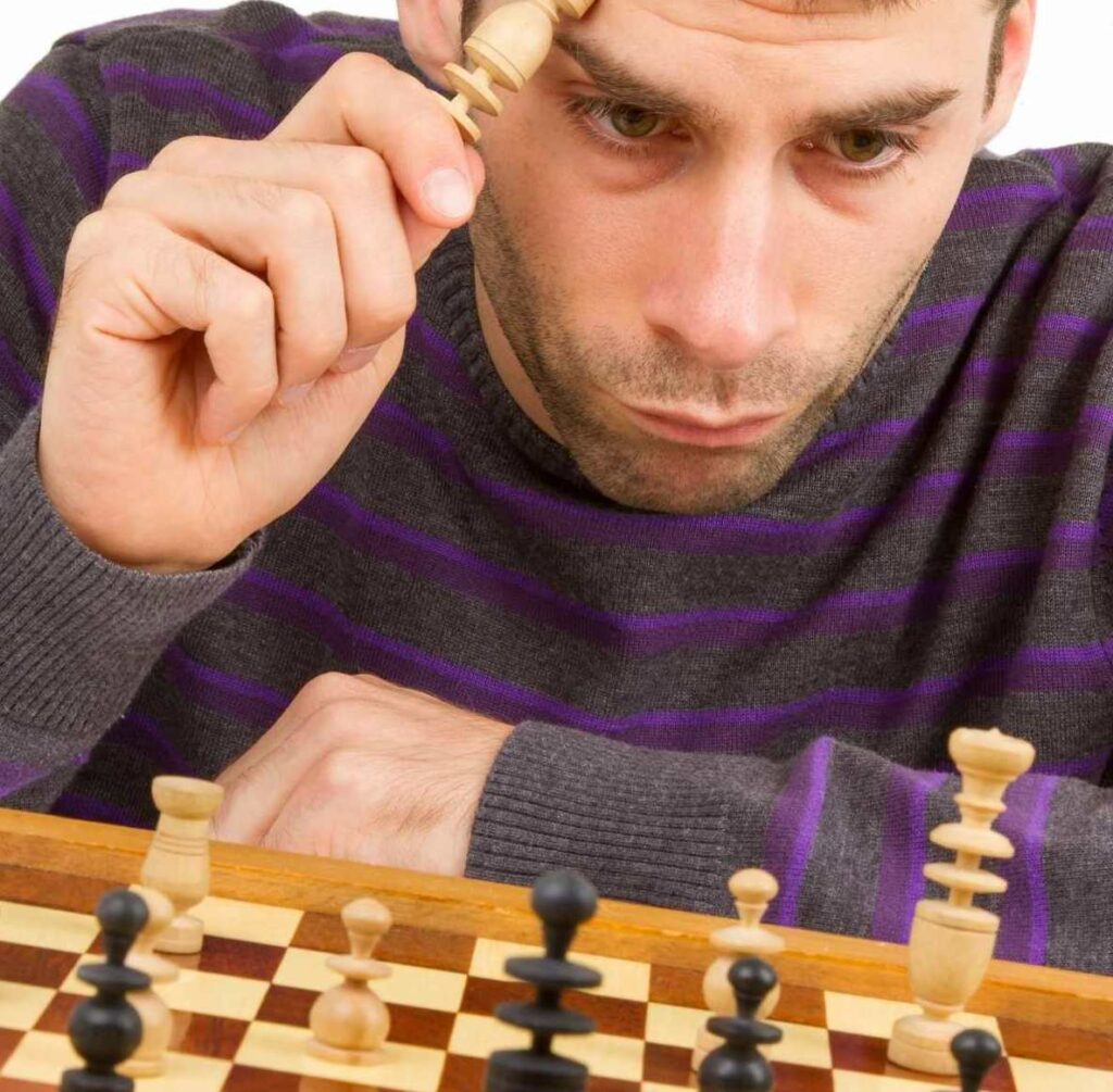 A man analyzing his weakness on a chess game