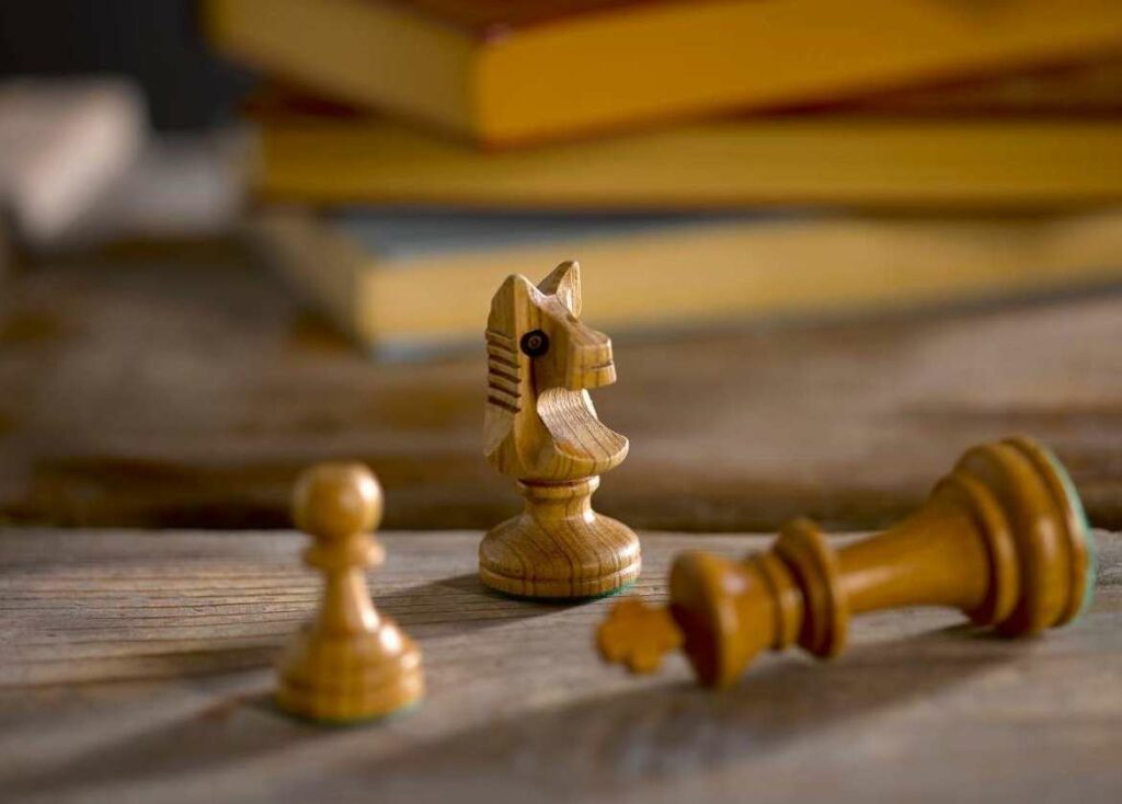 chess pieces with books in the background