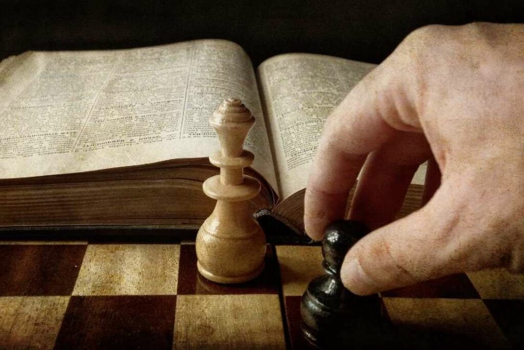 chess rule book and some pieces on a board