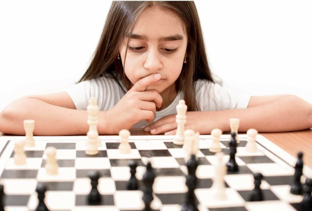 Young girl contemplating her next chess move